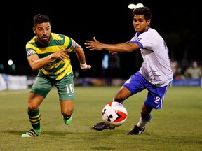 Tampa Bay Rowdies midfielder Juan Guerra, left, is able to get by FC Edmonton midfielder Shamit Shome in a North American Soccer League match in Tampa, Florida earlier this year. The two teams face each other again on Sunday at Clarke Stadium.