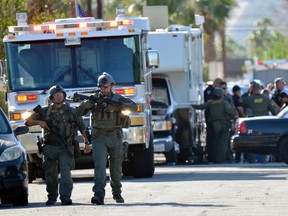 Riverside Country Sheriffs Deputies stand near the scene of a shooting in Palm Springs, Calif., Saturday, Oct. 8, 2016. Palm Springs police officers trying to resolve a family dispute were shot to death Saturday when a man they had been speaking calmly with suddenly pulled out a gun and opened fire on them, the city's police chief told reporters. (AP Photo/Rodrigo Peña)
