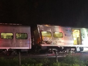 In this photo provided by Sarah Qamar shows a Long Island Railroad train derailed near New Hyde Park, N.Y., Saturday, Oct. 8, 2016. The commuter train derailed east of New York City after it hit a work train on the tracks. A spokesman for the Long Island Rail Road says the eastbound train derailed east of New Hyde Park just after 9 p.m. Saturday. A spokeswoman for the Nassau County Police Department says there are 50 to 100 injuries, none of them life-threatening. (Sarah Qamar via AP)
