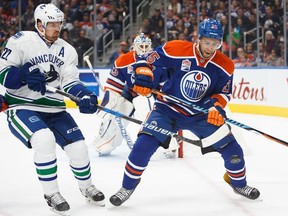 Edmonton's Darnell Nurse (25) defends against Vancouver's Daniel Sedin (22) during the Edmonton Oilers' NHL pre-season hockey game against the Vancouver Canucks at Rogers Place in Edmonton, Alta., on Saturday, Oct. 8, 2016.
