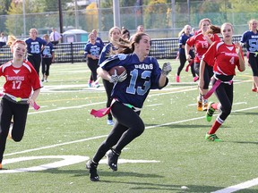 Erica Bichel, middle, of St. Benedict Bears, evades Adeline Faucon, left, and Mikayla Desrosiers, of Macdonald-Cartier Pantheres, during girls flag football action at James Jerome Sports Complex in Sudbury, Ont. on Thursday October 6, 2016. The Bears won 47-0. John Lappa/Sudbury Star/Postmedia Network