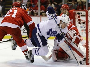 Toronto Maple Leafs forward Auston Matthews (34) trips in front of Detroit Red Wings goalie Petr Mrazek (34) during the second period of an NHL preseason hockey game, Saturday, Oct. 8, 2016, in Detroit. (AP Photo/Carlos Osorio)