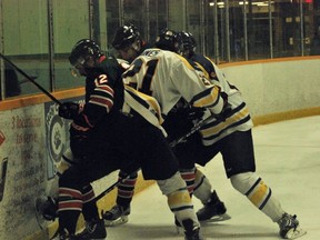 Keith Dempsey/For The Sudbury Star: Voyageurs' Darcy Haines battles with a UQTR player for the puck during OUA men's hockey action at Gerry McCrory Countryside Sports Complex on Saturday.