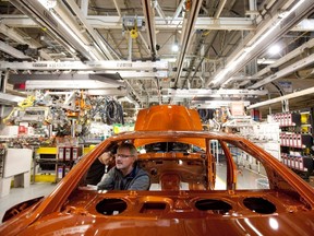 Chrysler Group LLC employees work on the assembly line during the production launch of Chrysler vehicles at the assembly plant in Brampton, Ont. January 7, 2011. THE CANADIAN PRESS/Darren Calabrese