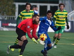 Shamit Shome of FC Edmonton, charges towards Matt Pickens of the Tampa Bay Rowdies at Clarke Field in Edmonton on October 9, 2016. Photo by Shaughn Butts / Postmedia