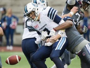 Toronto Argonauts quarterback Drew Willy is sacked by Montreal Alouettes' John Bowman during second half CFL football action against the Montreal Alouettes in Montreal, Sunday, October 2, 2016. (THE CANADIAN PRESS/Graham Hughes)