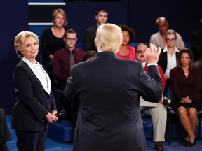 Democratic presidential nominee Hillary Clinton listens to Republican presidential nominee Donald Trump during the second presidential debate at Washington University in St. Louis, Sunday, Oct. 9, 2016. (Rick T. Wilking/Pool via AP)