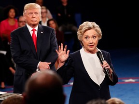 Democratic presidential nominee former Secretary of State Hillary Clinton (right)) speaks as Republican presidential nominee Donald Trump listens during the town hall debate at Washington University on October 9, 2016 in St Louis, Missouri. This is the second of three presidential debates scheduled prior to the November 8th election. (Photo by Rick Wilking-Pool/Getty Images)