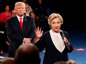 Democratic presidential nominee former Secretary of State Hillary Clinton (R) speaks as Republican presidential nominee Donald Trump listens during the town hall debate at Washington University on October 9, 2016 in St Louis, Missouri. This is the second of three presidential debates scheduled prior to the November 8th election. (Photo by Rick Wilking-Pool/Getty Images)