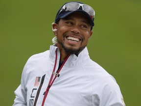 This file photo taken on September 28, 2016 shows USA Vice-Captain Tiger Woods smiling during a practice round ahead of the 41st Ryder Cup at Hazeltine National Golf Course in Chaska, Minnesota. (AFP PHOTO/JIM WATSON)