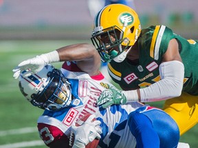 Montreal Alouettes' Brandon Rutley, left, is tackled by Edmonton Eskimos' Kenny Ladler during first half action in Montreal, Monday. (The Canadian Press)