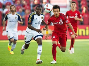 Toronto FC forward Tsubasa Endoh battles for the loose ball against Real Salt Lake midfielder Demar Phillips during a game earlier this season. (THE CANADIAN PRESS)