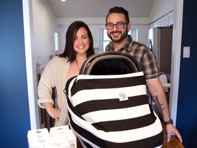 Sabrina and Michael Maulucci are making and selling the OVer ? a cotton cover for car seats, strollers and breast feeding. (DEREK RUTTAN, The London Free Press)