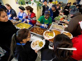 Volunteers help serve the annual community Thanksgiving dinner at the Millbourne Laundromat, 109 Millbourne Road East, in Edmonton on Monday Oct. 10, 2016. David Bloom/Postmedia
