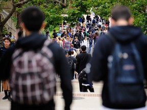 File photo of students walking across the campus of UCLA on April 23, 2012 in Los Angeles, California. (Photo by Kevork Djansezian/Getty Images)