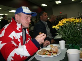 "Tim" enjoys a Thanksgiving meal served by volunteers at Toronto's Good Shepherd Centre on Queen St. E. on Monday, Oct. 10, 2016. (Terry Davidson/Toronto Sun)