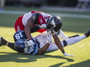 Toronto Argonauts Devin Smith and Calgary Stampeders Kamar Jordenduring 1st half CFL action at BMO Field in Toronto, Ont. on Monday October 10, 2016. (Ernest Doroszuk/Toronto Sun/Postmedia Network)