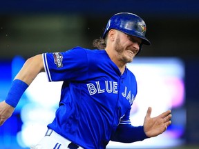Josh Donaldson of the Toronto Blue Jays scores off of an RBI single hit by Edwin Encarnacion against the Texas Rangers in the third inning during game three of the American League Division Series. (Vaughn Ridley/Getty Images)