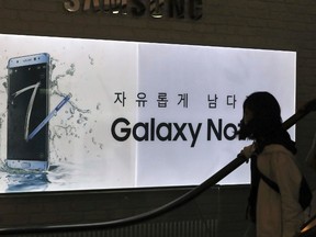 A visitor passes by an advertisement of the Samsung Electronics Galaxy Note 7 smartphone at its shop in Seoul, South Korea, Tuesday, Oct. 11, 2016. Samsung says it is halting sales of the Galaxy Note 7 smartphone after a spate of fires involving new devices that were supposed to be safe replacements for recalled models. THE CANADIAN PRESS/AP-Lee Jin-man