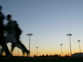 In this Thursday, Jan. 22, 2004 file photo, students jog around a stadium at sunset in Bowling Green, Ky. A large, international study released on Monday, Oct. 10, 2016, ties heavy exertion while stressed or mad to a tripled risk of having a heart attack within an hour. (Clinton Lewis/Daily News via AP)