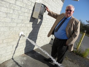 Ernst Kuglin/The Intelligencer
Quinte West Mayor Jim Harrison was the first to use the coin operated water dispenser at the bulk water station on Parry Drive in Batawa. The city installed the system due to the on going drought conditions. The minimum charge is $1.
