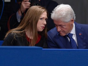 Chelsea Clinton, daughter of Hillary Clinton, talks to former President Bill Clinton during the second presidential debate between Republican presidential nominee Donald Trump and Democratic presidential nominee Hillary Clinton at Washington University in St. Louis, Sunday, Oct. 9, 2016. (Saul Loeb/Pool via AP)