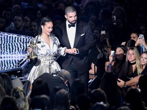 Rihanna, left, is escorted by presenter Drake after she accepted the Michael Jackson Video Vanguard Award at the MTV Video Music Awards at Madison Square Garden on Sunday, Aug. 28, 2016, in New York.(Photo by Chris Pizzello/Invision/AP)