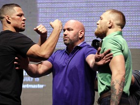 In this July 7, 2016, file photo, Dana White, centre, stands between Nate Diaz, left, and Conor McGregor during a news conference in Las Vegas for UFC 202. (AP Photo/John Locher, File)