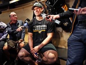 Penguins captain Sidney Crosby talks with reporters at his locker after skating at the team's practice facility in Cranberry Township, Pa., on Tuesday, Oct. 11, 2016. (Gene J. Puskar/AP Photo)