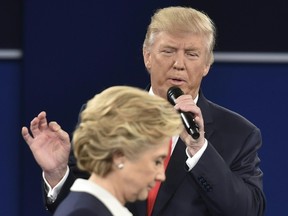 Republican presidential candidate Donald Trump speaks as Democratic presidential candidate Hillary Clinton walks past during the second presidential debate at Washington University in St. Louis, Missouri on October 9, 2016. / AFP PHOTO / Paul J. RichardsPAUL J. RICHARDS/AFP/Getty Images
