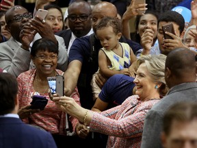 Democratic presidential candidate Hillary Clinton poses for photos after speaking at a rally at Miami Dade College in Miami, Tuesday, Oct. 11, 2016. (Mike Stocker/South Florida Sun-Sentinel via AP)