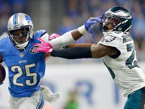 Detroit Lions' Theo Riddick stiff arms an Eagles defender during Sunday's win over Philadelphia. (GETTY IMAGES)