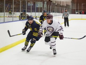 NAIT Ooks veteran Tanner Dunkle and Grant MacEwan Griffins rookie Austin Yaremchuk go shoulder-to-shoulder during the Griffins’ 4-2 Friday victory that ended the full-season 2015-16 NAIT unbeaten streak — including playoffs — that included an ACAC championship and extended through the Ooks’ first two games of the season. One night later, in another 4-2 triumph, Yaremchuk helped to start the comeback from a 2-0 deficit with an assist on a goal by another Yaremchuk — brother Nolan. (Courtesy NAIT)