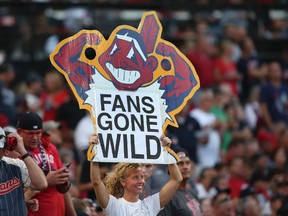 A Cleveland Indians fan holds a sign during Game 2 of an American League Division Series against the Boston Red Sox in Cleveland on Oct. 7. (Aaron Josefczyk/Associated Press)