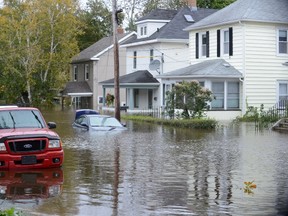 A vehicle is submerged in a residential area of Sydney, N.S., Tuesday, Oct. 11, 2016. THE CANADIAN PRESS/Vaughan Merchant