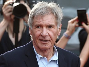 FILE - In this December 10, 2015 file photo, Harrison Ford greets fans during a Star Wars fan event in Sydney. A film production company has been fined 1.6 million pounds ($1.95 million) over an accident on the set of "Star Wars: The Force Awakens" that broke the leg of star Harrison Ford. The actor was struck by a hydraulic door on the set of the Millennium Falcon — his character Han Solo's spaceship — at Pinewood Studios near London in June 2014. A judge at Aylesbury Crown Court north of London said Wednesday, Oct. 12, 2016 that Foodles Production (UK) Ltd. should have informed Ford of the risks.