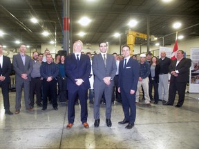 London North Centre MP Peter Fragiskatos, centre, with ArcelorMittal Tailored Blanks vice-president Ben Orler, left, and president Todd Baker, right, stand in front of employees following the announcement of a $12.73-million investment in the company on Wednesday. (HEATHER RIVERS, Sentinel-Review)