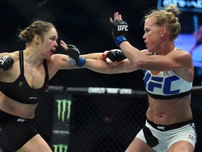 Ronda Rousey (left) and Holly Holm fight during their UFC 193 bantamweight title bout in Melbourne, Australia, on Nov. 15, 2015. Rousey will return to the UFC on Dec. 30 in Las Vegas, fighting Amanda Nunes for the bantamweight title. (Andy Brownbill/AP Photo/Files)