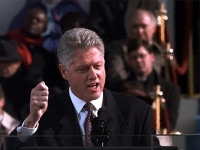 This Jan. 20, 1997 file photo shows U.S. President Bill Clinton gesturing while speaking during his inaugural speech after being sworn in for his second term, on Capitol Hill in Washington. (AP Photo/Ron Edmonds)