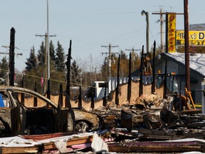 Detroyed vehicles and buildings are seen at the scene of a fatal fire at the Bashaw Motor Inn in Bashaw, Alberta on Tuesday, October 11, 2016. The fire broke out on Oct. 9. Ian Kucerak / Postmedia