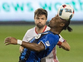 TFC’s Drew Moor (left) vies for the ball with the Impact’s Didier Drogba. The teams meet on Sunday. (Canadian Press)