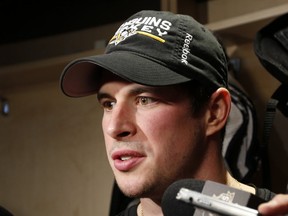 Pittsburgh Penguins' Sidney Crosby talks with reporters at his locker after skating at the Penguins' practice facility in Cranberry Township, Pa., Tuesday, Oct. 11, 2016. Crosby was diagnosed with a concussion by team doctors Monday. (AP Photo/Gene J. Puskar)