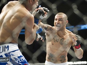 Cub Swanson, right, throws a punch during his fight with Charles Oliveira at UFC 152 in Toronto on Saturday, Sept. 22, 2012. (THE CANADIAN PRESS/Nathan Denette)