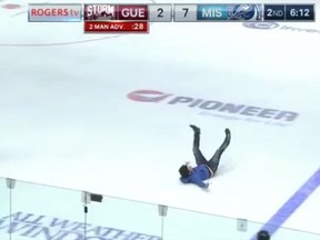 A fan enters the ice surface, falls during a Guelph Storm-Mississauga Steelheads game on Oct. 12. (Screen grab)