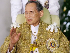 Thailand's King Bhumibol Adulyadej waves to well-wishers as he returns to Siriraj Hospital after attending a ceremony to celebrate his birthday in Bangkok. (AP Photo, File)