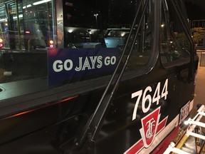 A TTC bus with a 'Go Jays Go' sign in Toronto on Thursday, Oct. 13, 2016 (Don Peat/Toronto Sun/Postmedia Network)