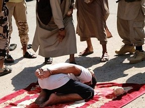Shocking photos have emerged of ISIS stoning two men to death for reportedly committing adultery. (Amaq News Agency)