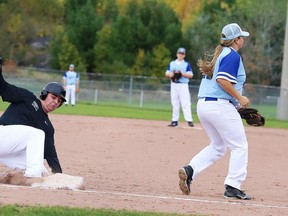 Michel Roux of L'Horizon slides into third base as Julia Jodouin of the St. Benedict Bears makes the catch during high school baseball action in Sudbury on Wednesday. Gino Donato/Sudbury Star
