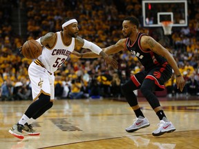 Cavaliers' Mo Williams (left) looks for space against Raptors' Norman Powell (right) during Game 5 of the NBA Eastern Conference Final in Cleveland on May 26, 2016. (Jack Boland/Toronto Sun)