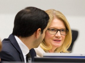 London North Centre MP Peter Fragiskatos listens as London-West MP Kate Young talks with city politicians while discussing local issues at City Hall in London, Ont. on Tuesday October 11, 2016. (CRAIG GLOVER, The London Free Press)
